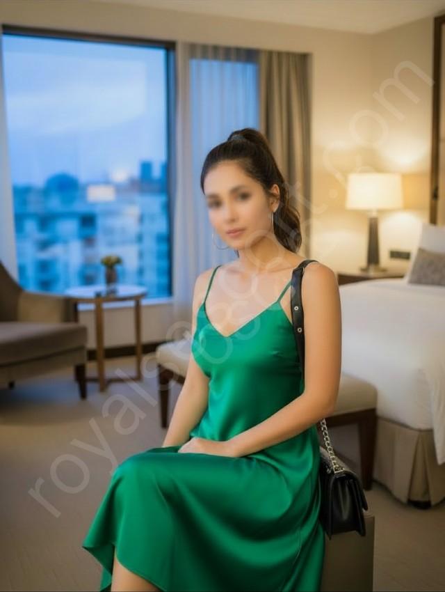 Avika call girl Escort wearing green colour gown and sitting in hotel room in Mussoorie