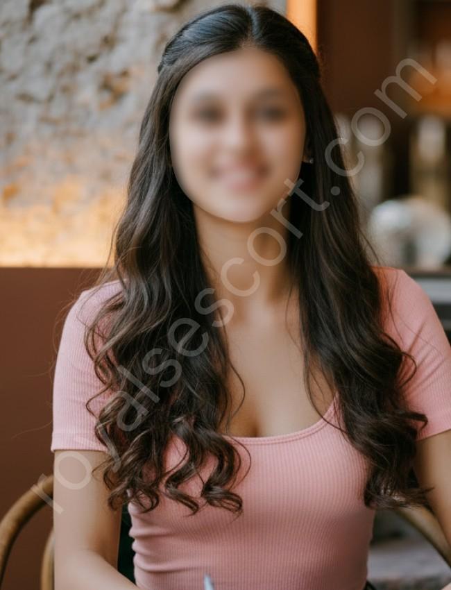 Eshani Escort & Call Girl sitting on chair wearing brown top