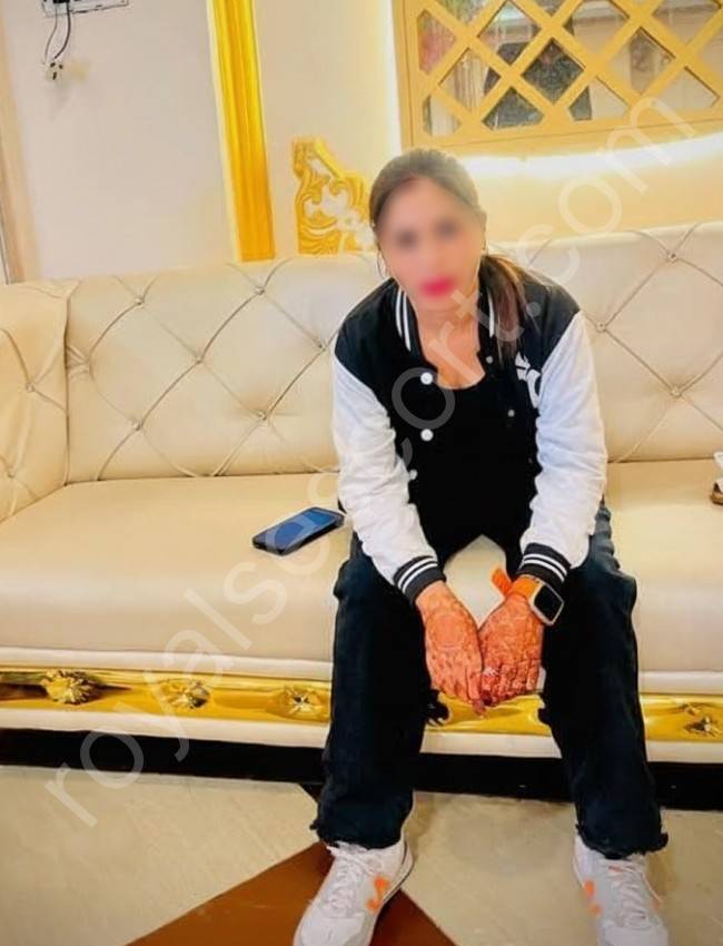 Hibal Escort in Hyderabad wearing funky look sitting on sofa