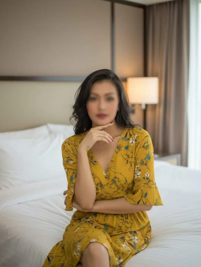  Kavyanshi Model escort in zirakpur wearing yellow dress and sitting on bed