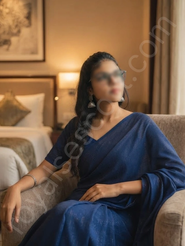 Bangalore escort service meher wearing saree and sitting on sofa