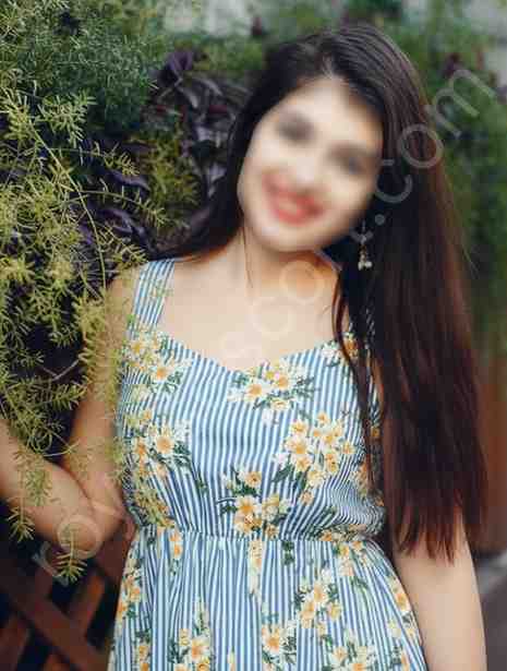 Independent call girl wearing flower dress and smiling in Hyderabad garden