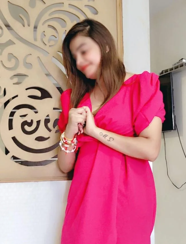 Independent call girl in laxman jhula Riddhi wearing red dress give side pose standing with decorative background