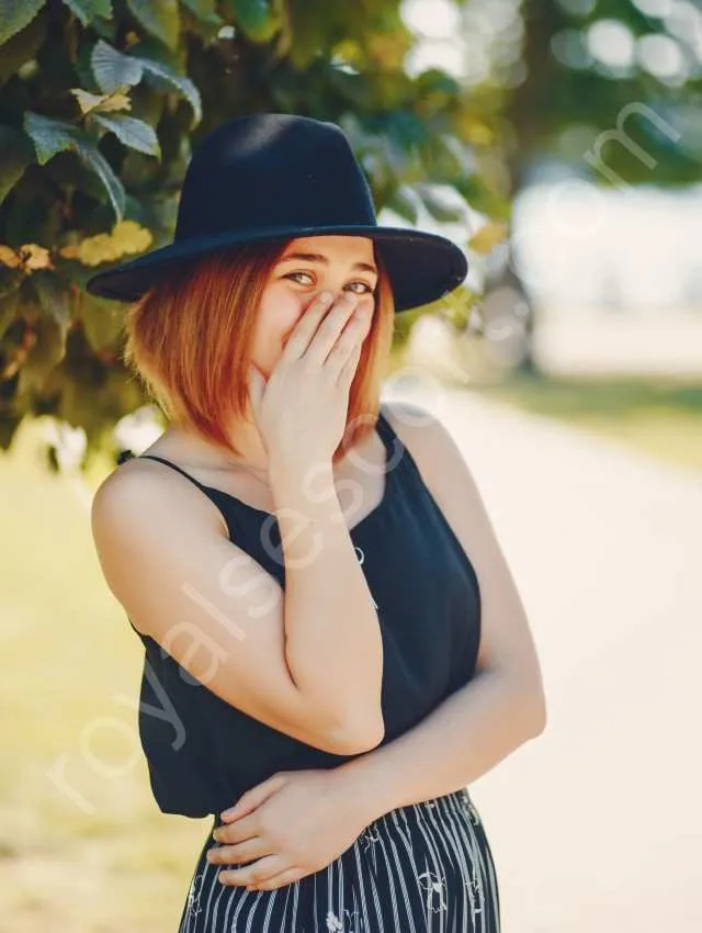 Independent Pune Escort Riya wearing black top and hat and give smiling pose in garden